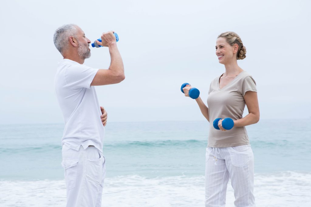 Fit couple doing sport at the beach