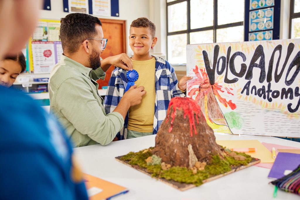 Proud schoolboy wins the award for best science project at elementary school