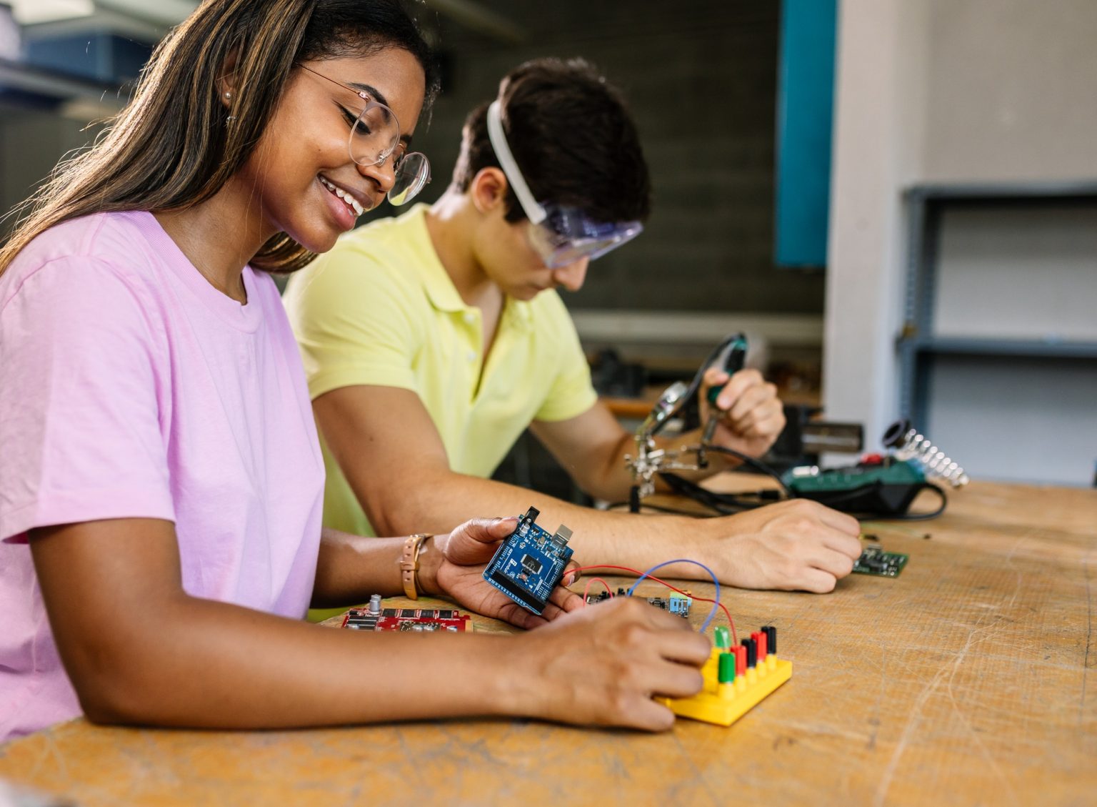 Young high school students learning together at stem robotics class